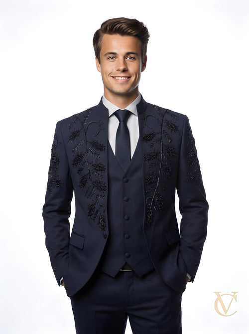 Man wearing a tailored 3-Piece Suit | Vellure Couture in deep navy with intricate black bead embellishments and a sculpted fit, paired with a matching tie and crisp white shirt.