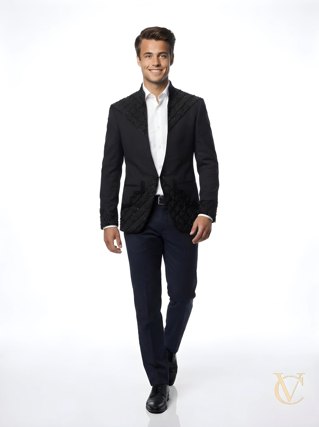 A confident man wearing the 2-Piece Suit - Black | Vellure Couture, featuring a tailored jacket with detailed embellishments and classic black trousers, styled with a white shirt.