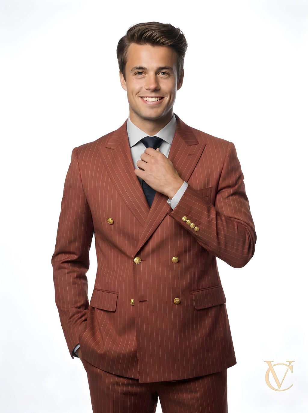 A confident young man wearing a tailored 2-Piece Suit - Burgundy | Vellure Couture, featuring a double-breasted jacket with gold buttons and slim-fit trousers, styled with a light shirt and dark tie.