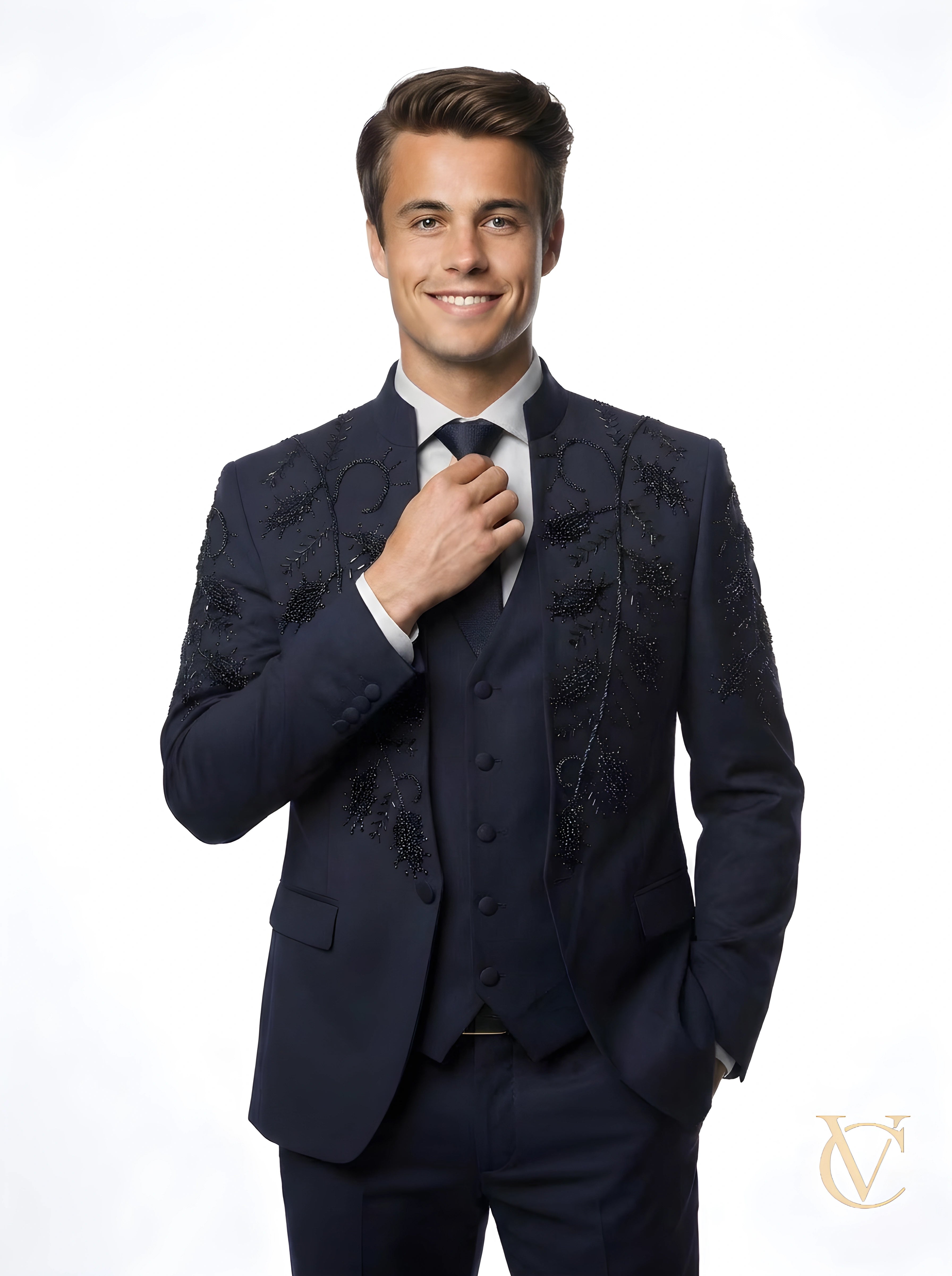 Man wearing a navy tailored 3-Piece Suit | Vellure Couture with intricate bead embellishments on the jacket, styled with a white shirt and matching tie, smiling confidently.