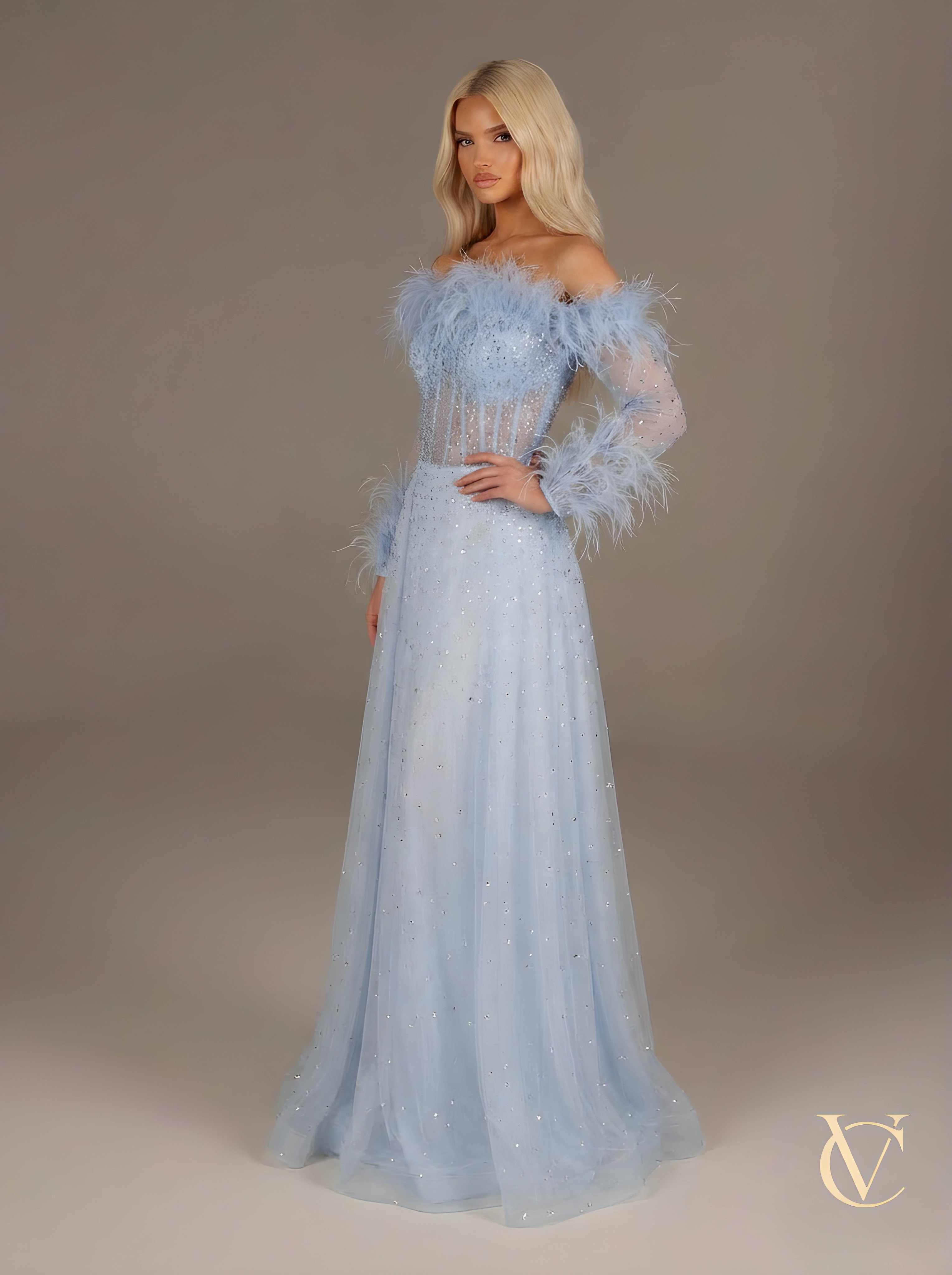 Model wearing Crystal feather Dress - Blue | Vellure Couture, an elegant evening gown featuring crystal embellishments and feather details on the bodice and sleeves, showcasing a sculpted fit and luxury finish.