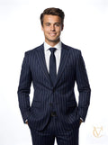Young man wearing a tailored 2-Piece Suit - Navy Striped | Vellure Couture with a white shirt and navy tie, showcasing a modern, elegant luxury tailored suit.
