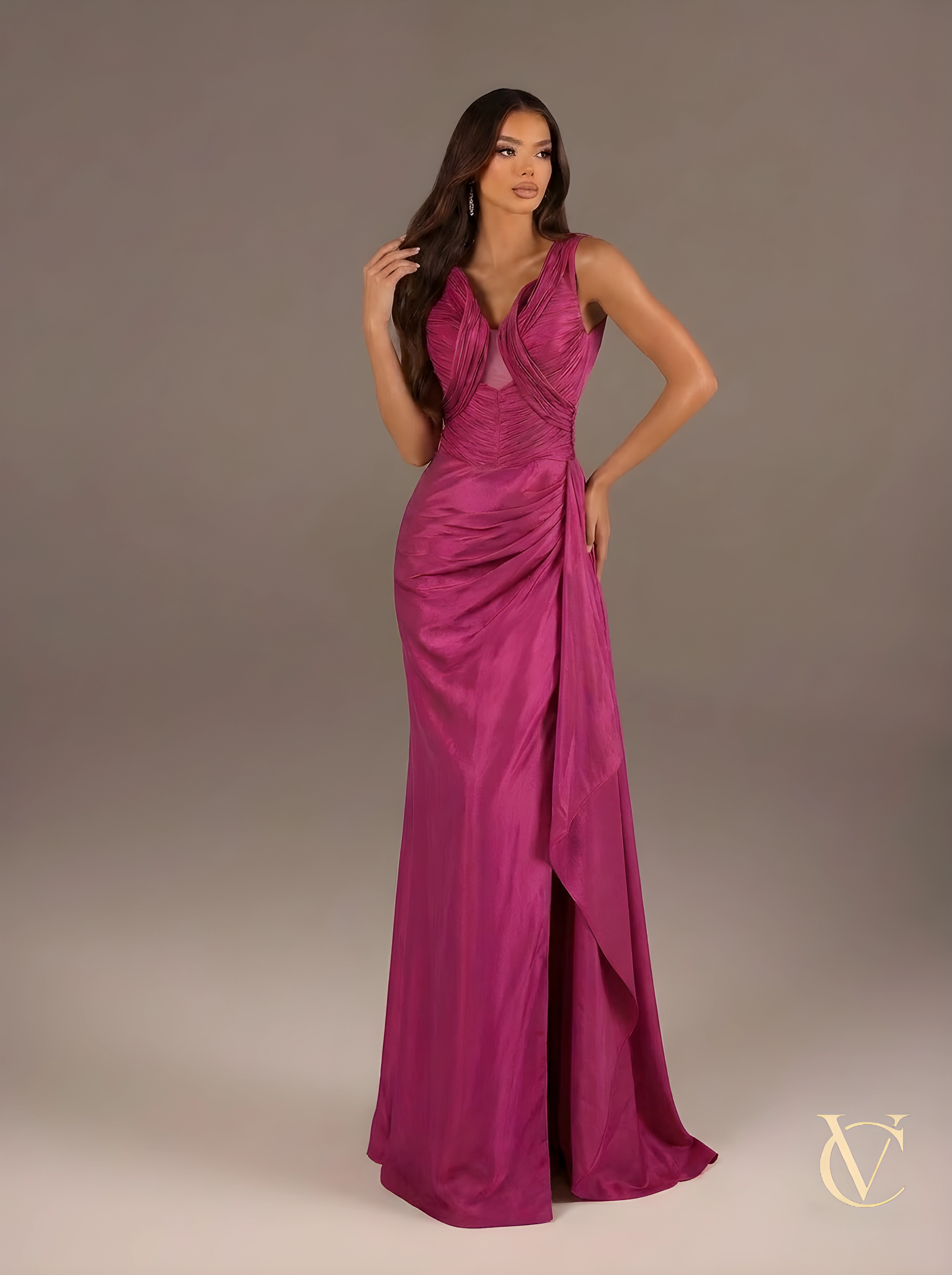 Woman wearing a vibrant pink evening gown against a neutral background